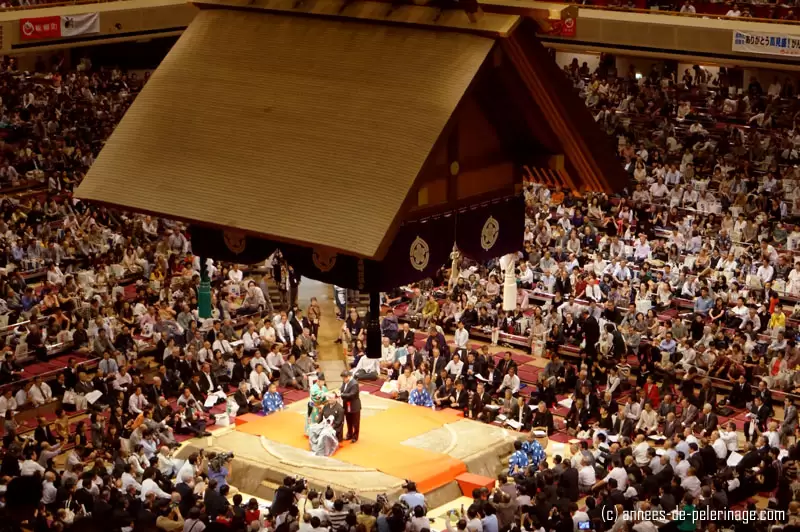 A retirering sumo wrestlers get his hair cut in a ritual ceremony in the sumo ring