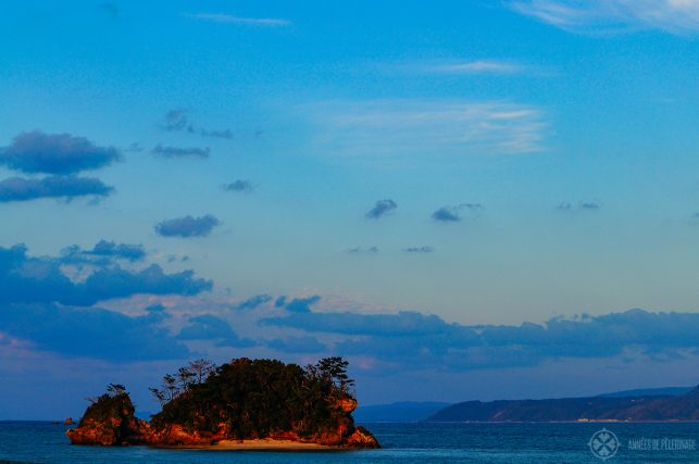 a small island off the coast of Okinawa near sunset