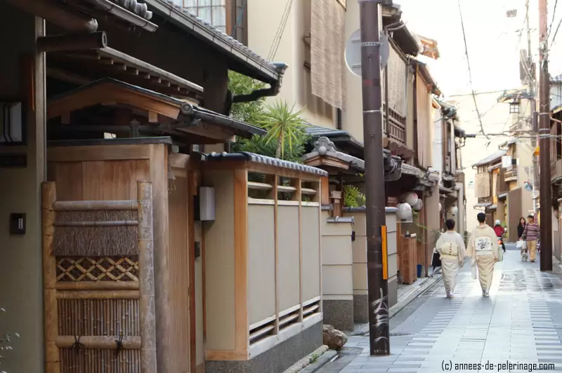 two japanese women in the streets of gion, kyoto with traditional kimono