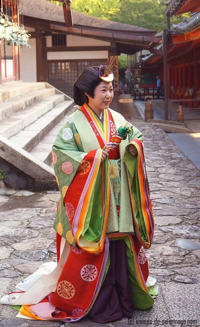 Full profile of a womandessed as a noble women from the Heian period wearing a junihitoe