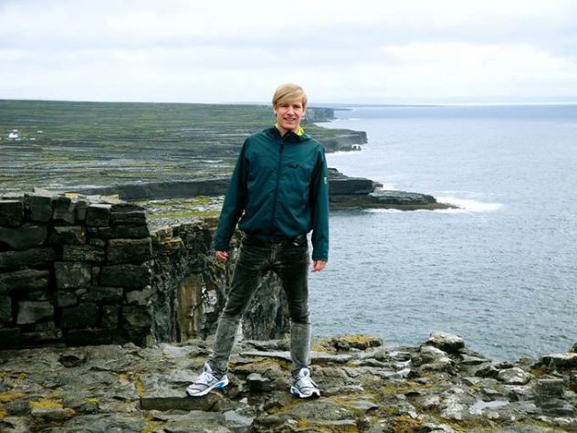 me on vertical cliffs in Dún Aonghasa, Ireland