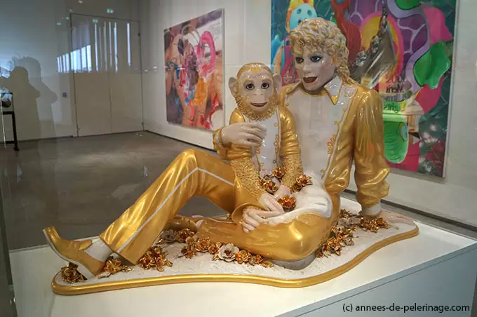 The golden ceramic Statue of Micheal Jackson hold his chimapnzee Bubble by Jeff koons in Astrup fearnley Museeum in Oslo