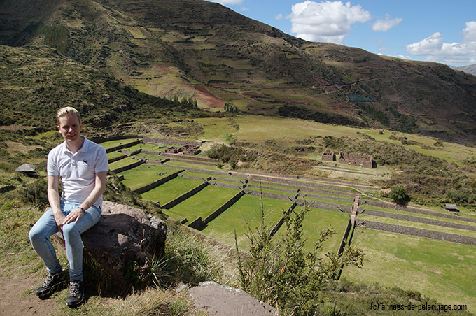 Me visiting tipon and sitting high above with the inca terraces in the background