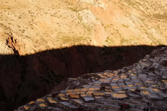 Sunset with orange reflections in the Maras Salt evaporation ponds