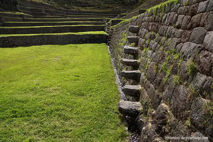 view along the water channels and the stairs connecting the different terrace levels in tipon