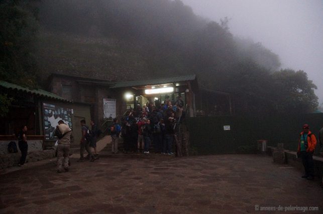 The entrance of Machu Picchu at 6 am in the morning before dawn hidden in the mists