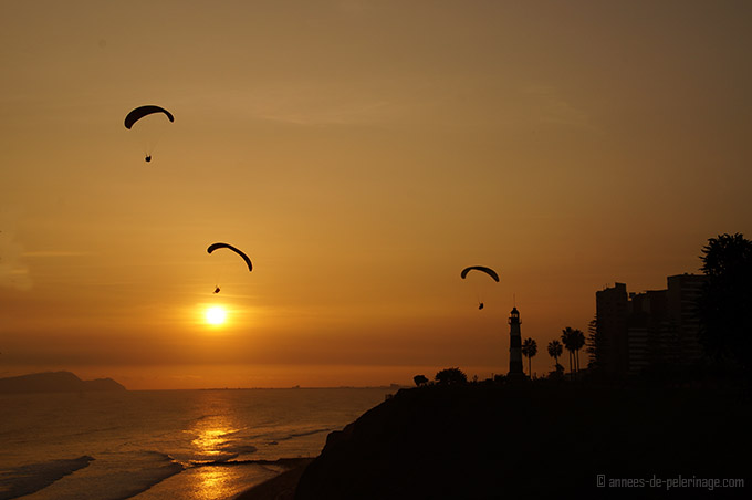 The miraflores district in lima at sunset with paragliders in the air. number 1 destination on my peru itinerary