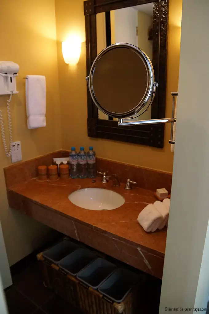 The tiny bathroom of the belmond sanctuary lodge luxury hotel - sink, hairdryer, mirror and bathing kit all on 2 square meter