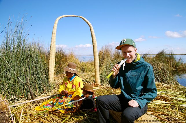 Me eating the bottom half of the totora reeds - the main staple of thei Uros' diet. For lake Titicaca you will need to pack warmer clothes as you can see