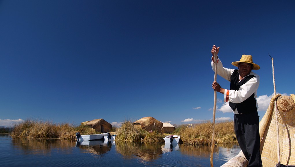 Leaving the floating Island of the uros to go cutting totora reeds in one of their traditional boats