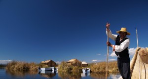 Leaving the floating Island of the uros to go cutting totora reeds in one of their traditional boats
