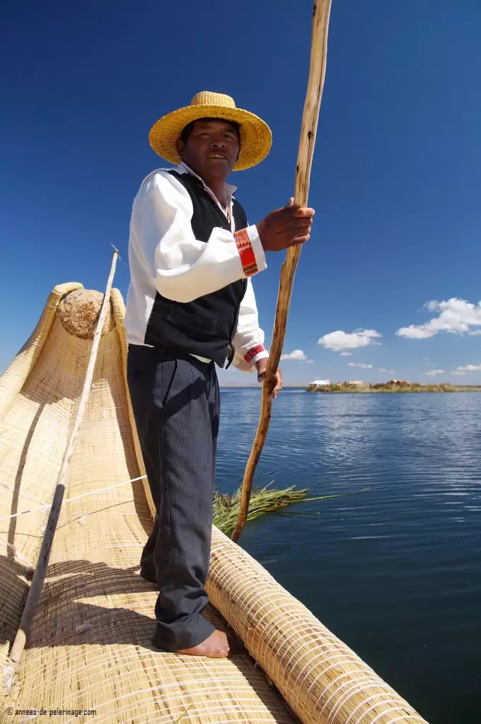 John steering a reed boat of the Uros people with freshly cut totora trailing behind