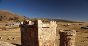 Ancient aymara chullpas near lake titicaca peru, overlooking a small settlement in the ilava district