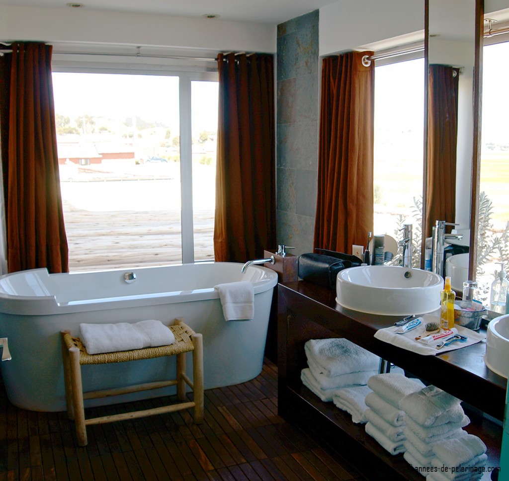 bathroom with huge bath tub and beautiful view at titilaka luxury lodge peru