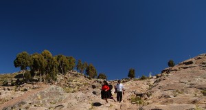 a couple of Taquileños walking down a steep hill on Taquile Island Lake titicaca, peru