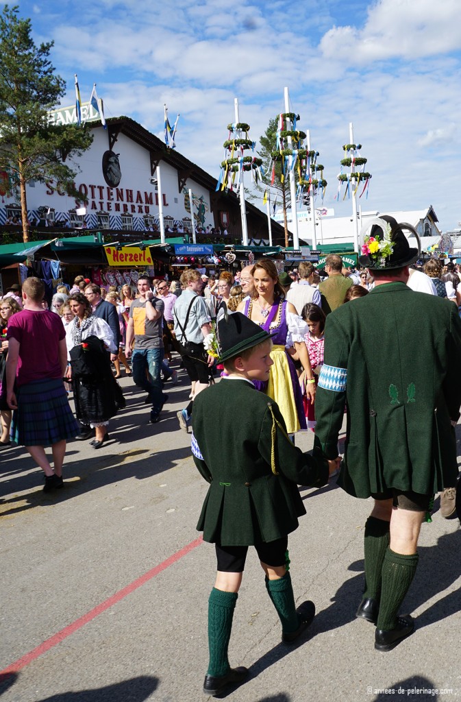 Locals strolling over oktoberfest in munich in dark green colors