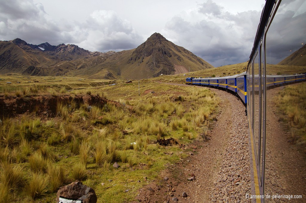 The Peru Rail Andean Explorer with high mountains behind it