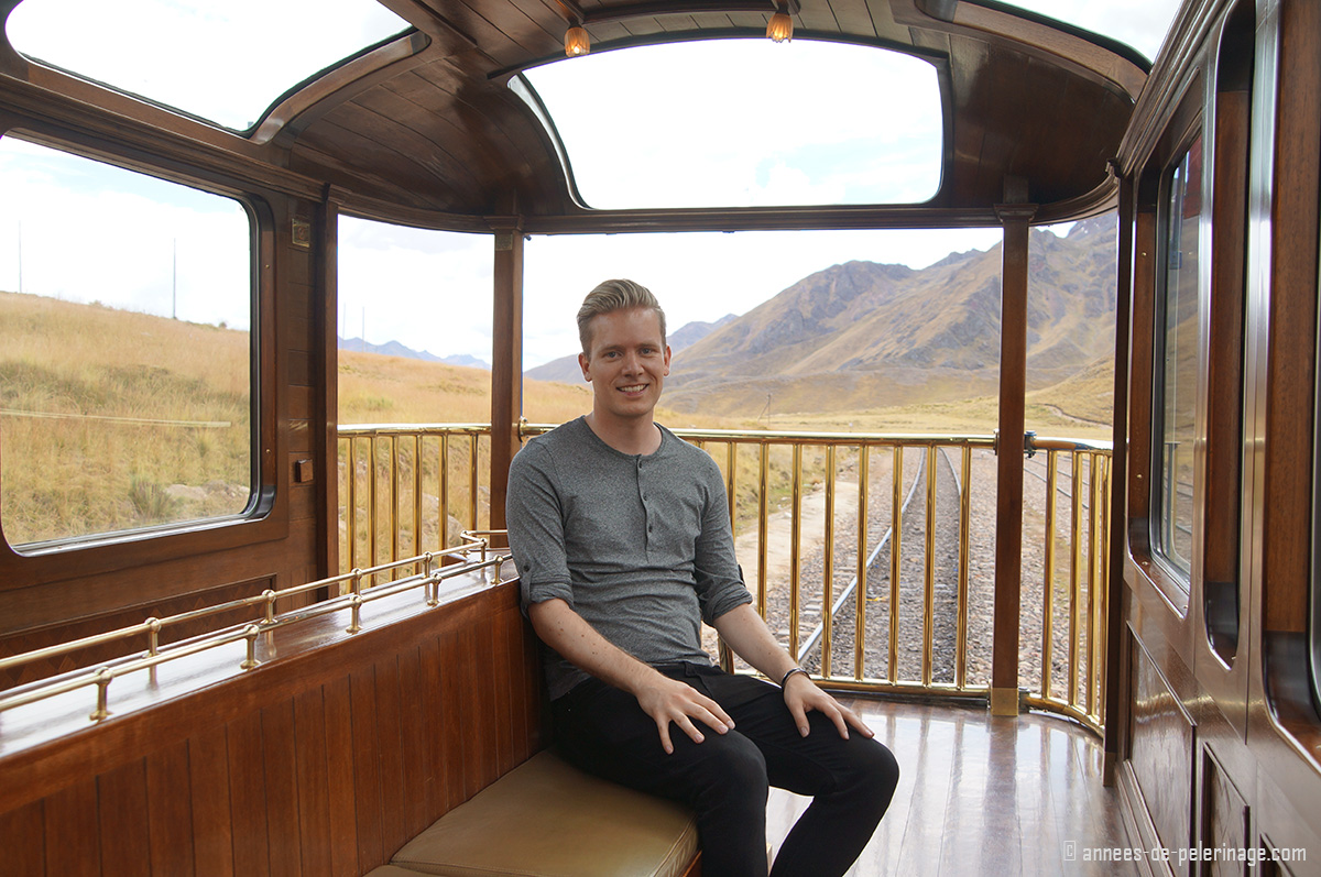 Me sitting on the luxury train by peru rail, called Andean Explorer, on the last wagon, ie the observation deck