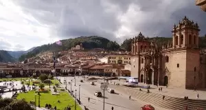 The beautiful Plaza de Armas bathed in golden sunlight in Cusco, Peru