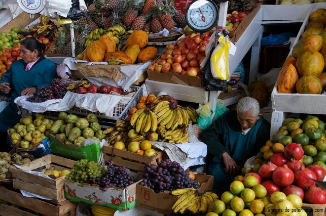 A fruit vendor sleeping in the middle of her wares in San Pedro markets