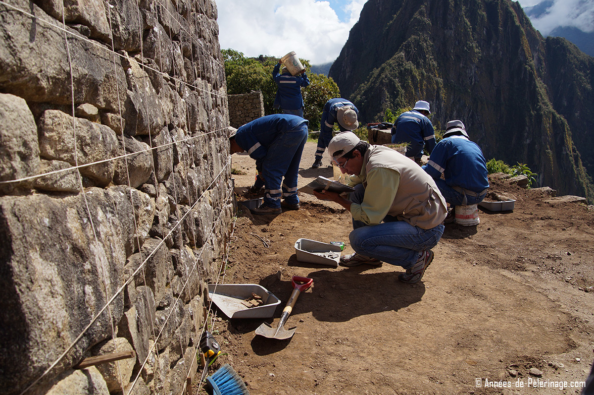 Archeologist working on a wall studying the Machu Picchu architecture