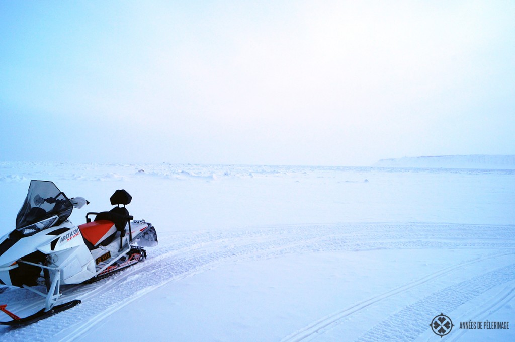A snow mobile standing at the border to the endless pack ice on spitsbergen