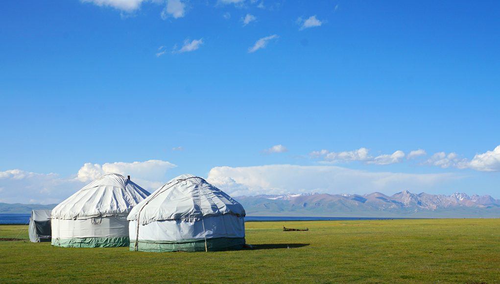 Son-kul lake with two yurts standing near its shore in Kyrgyzstan, just one of many free things to do in Kyrgyzstan, Central Asia