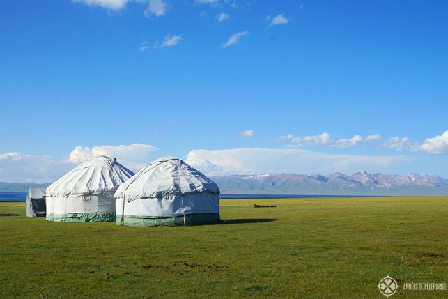 Son-kul lake with two yurts standing near its shore in Kyrgyzstan