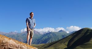 Me standing on a rock an Kyrgyzstan and contemplating my travels around the world