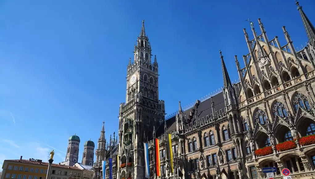 The marienplatz in Munich with its neo-gothic city hall and the frauenkirche in the background