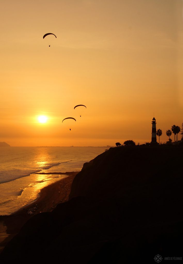 Sunset in Lima with paragliders on the coastline along Miraflores