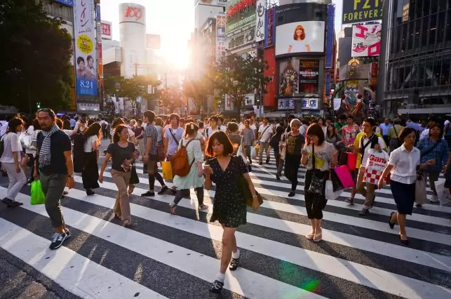 The Shibuya pedestrian crossing as people scramble over it