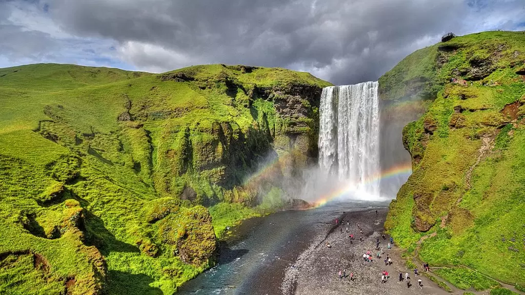 Skogafoss waterfalls in Iceland in summer with two rainbows