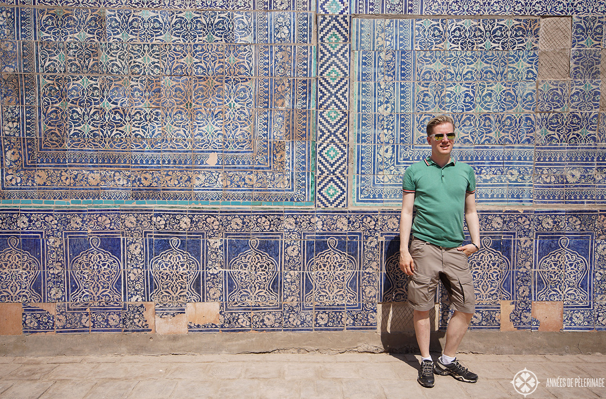 Me standing in front of wall with blue tiles in Khiva, Uzbekistan