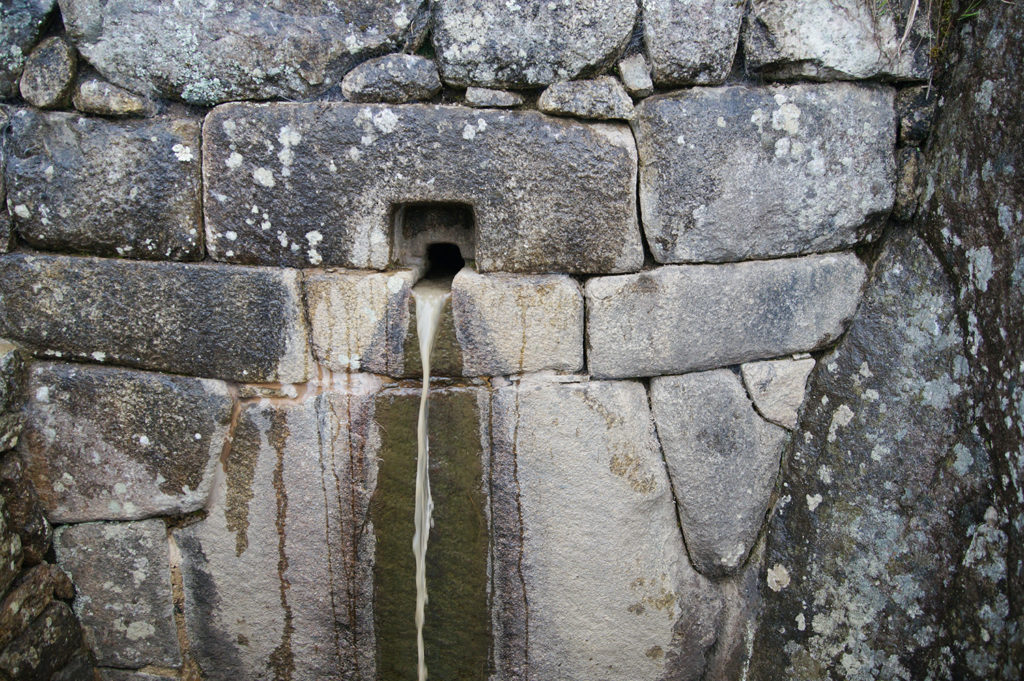 Water drains below the city wall are typical for the Machu Picchu architecture