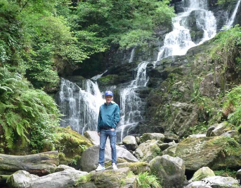 Me standing in front of a waterfall in Ireland. As you can see, I packed a rain coat, trainers and a hat. I think those are essential