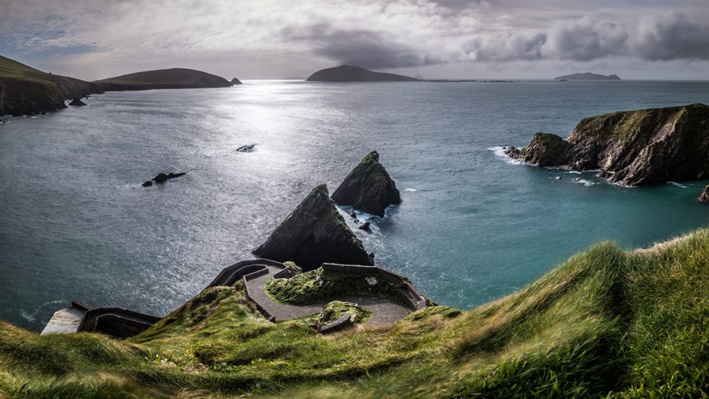 Dunquin harbour with a meandering road and the coast