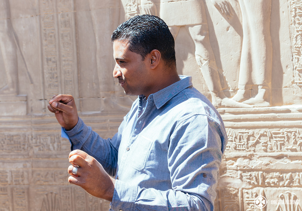 A Egyptian travel guide explaining some reliefs in an ancient Egyptian Temple