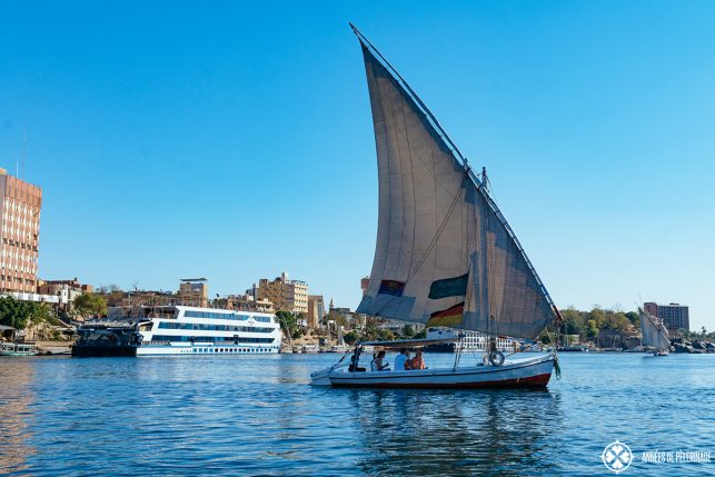 The oberoi Zahra luxury nile cruise ship with a traditional Felucca in Aswan, Egypt