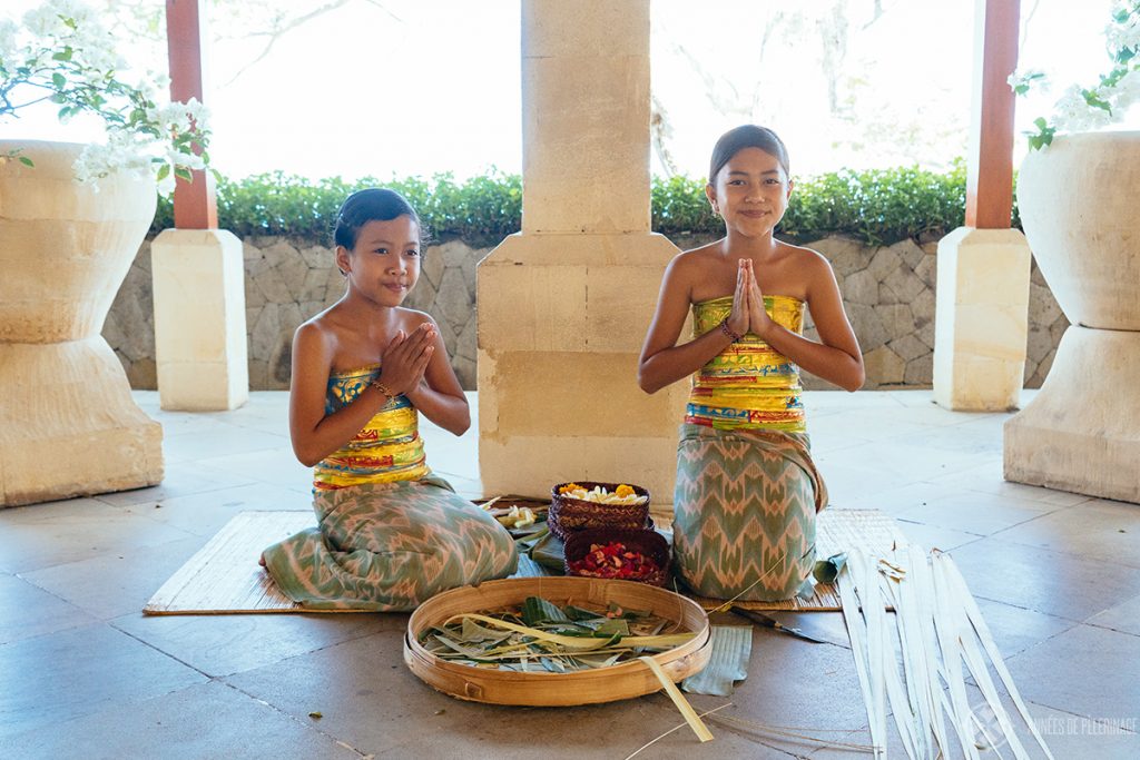 Girls preparing traditional Hindu offerings in the Lobby of the Amankila luxury hotel