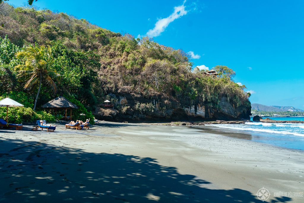 Private beach with Hindu temple on the cliff at the Amankila luxury hotel in East bali