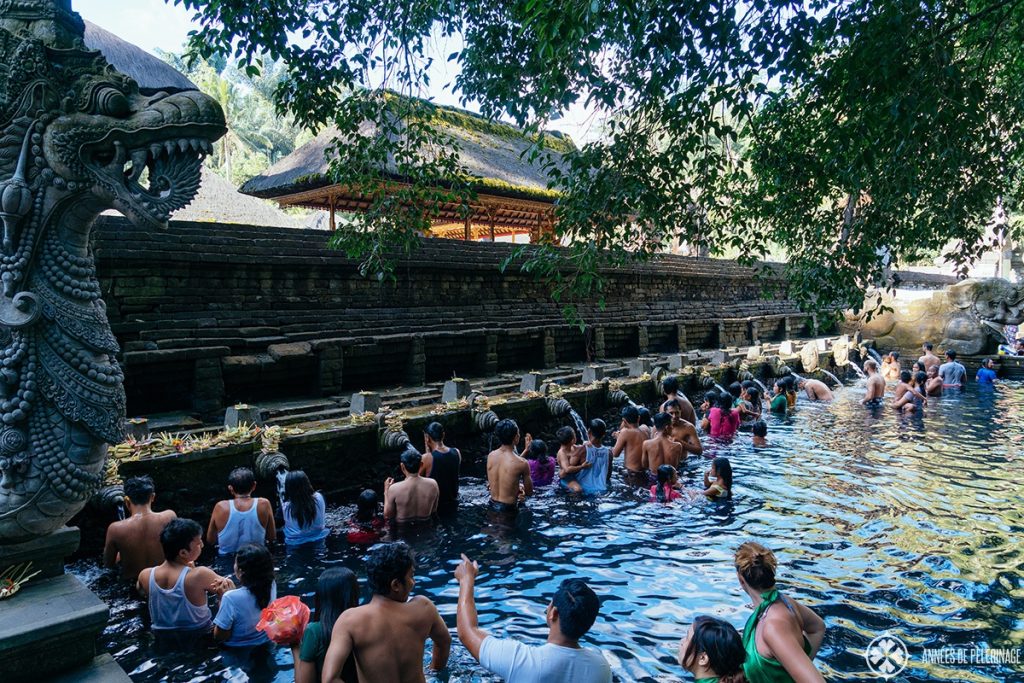 Believers going through the cleansing ritual at the tirta Empul water temple in Bali, Indonesia