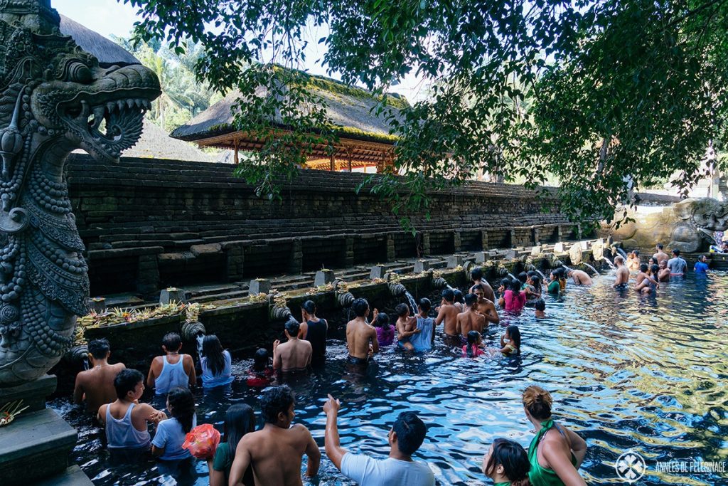 Believers going through the cleansing ritual at the tirta Empul water temple in Bali, Indonesia