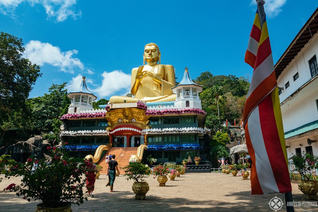 The golden Buddha at the foot of the hill leading towards the Dambulla Cave temple