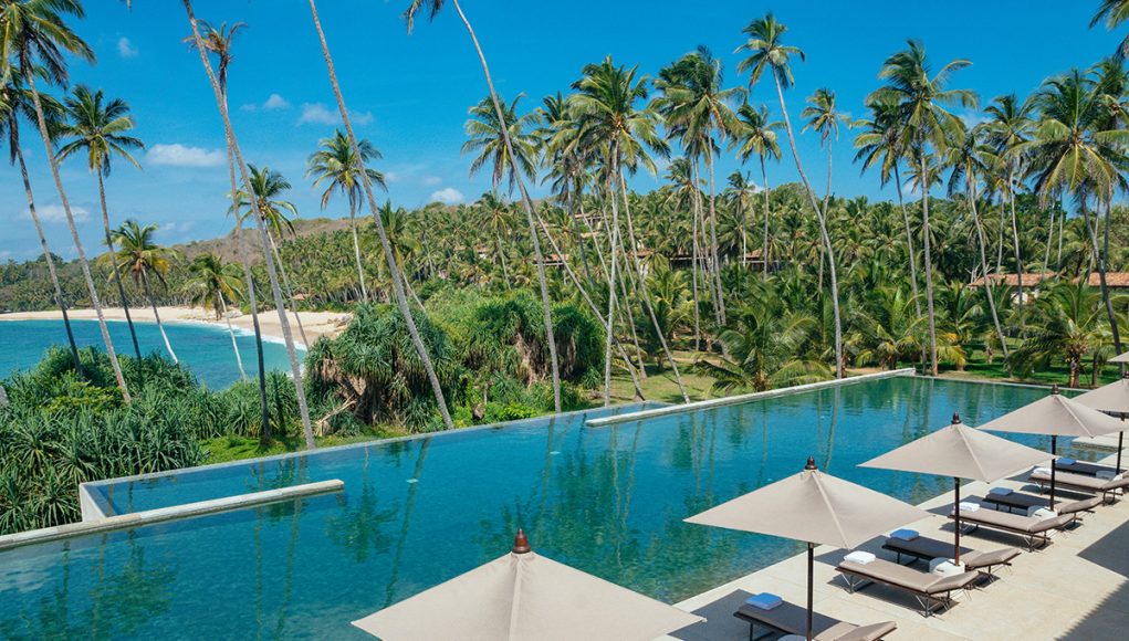 View of the main pool and the beach beyond at Amanwella Sri Lanka