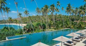 View of the main pool and the beach beyond at Amanwella Sri Lanka