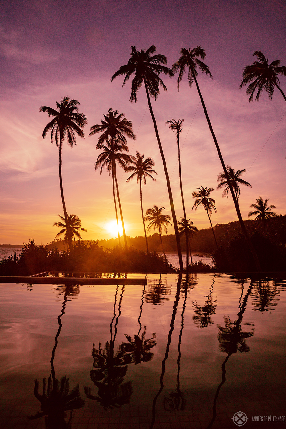 Golden sunset from the cocktail bar with the mainpool of Amanwella in the foreground