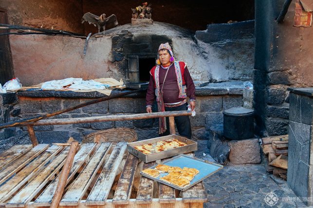 A local preparing fresh empanadas - just one of many street food options in Pisac market