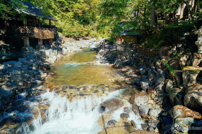 View along the mountain river with the outdoor pools of Takaragawa onsen on each side