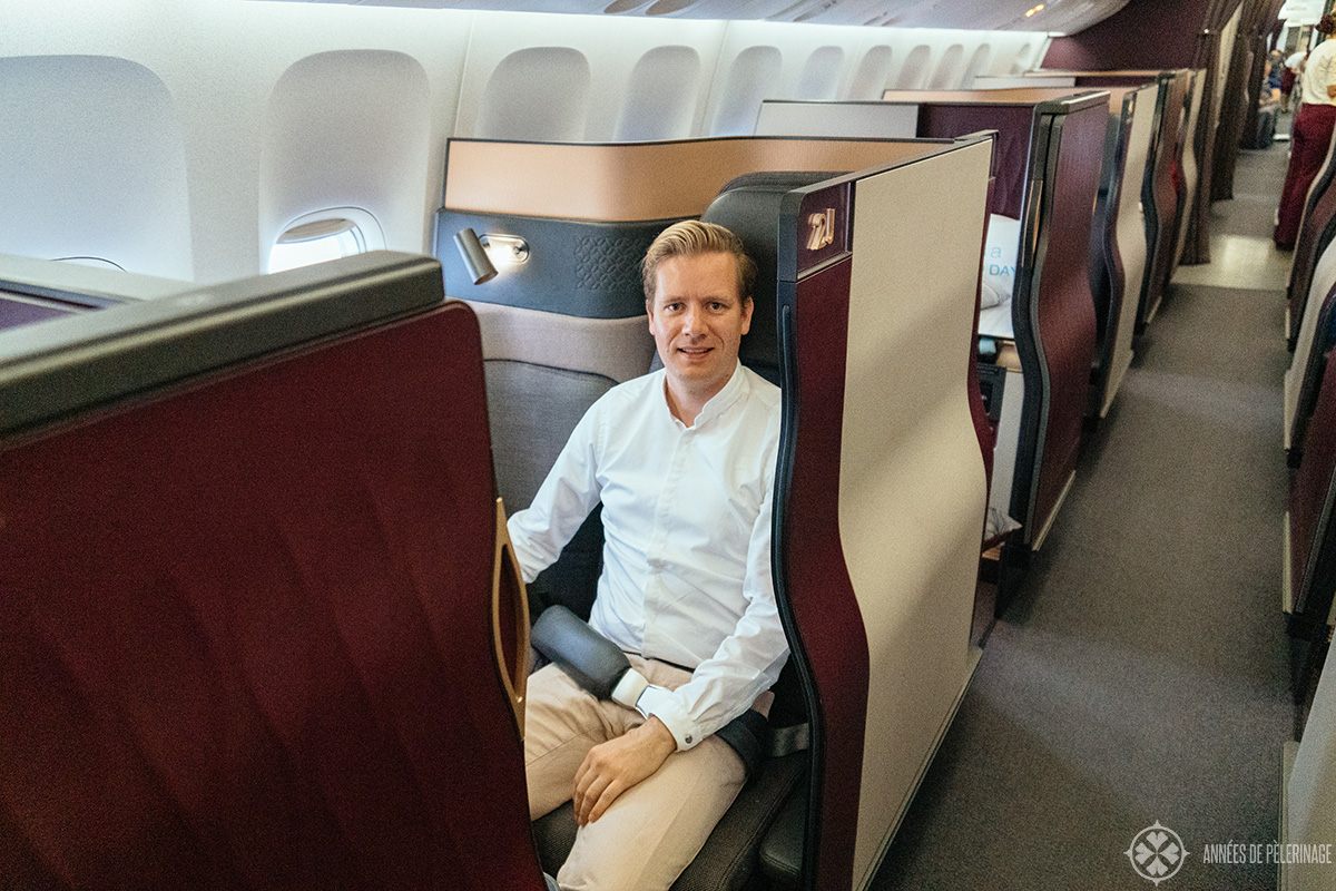 me sitting in business class of qatar airways